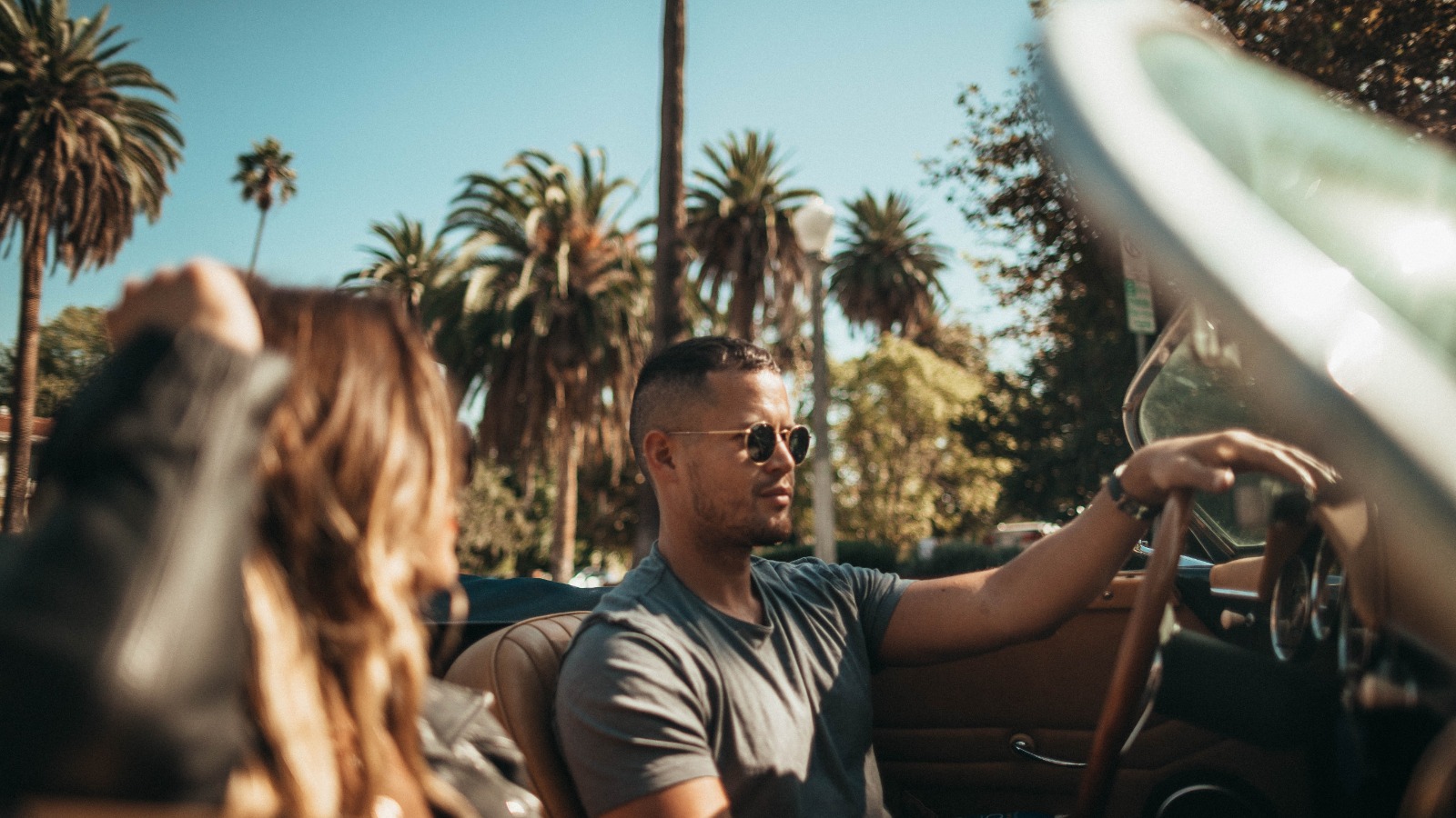 Photo “Man and Woman Riding Convertible Car” by Roberto Nickson